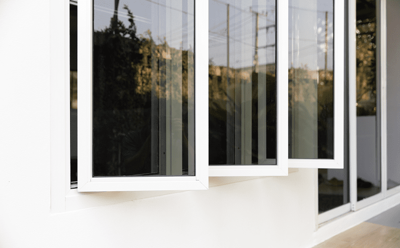 Open white-framed windows on a building.